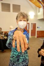Judy Goldman displaying her Halloween jewelry
